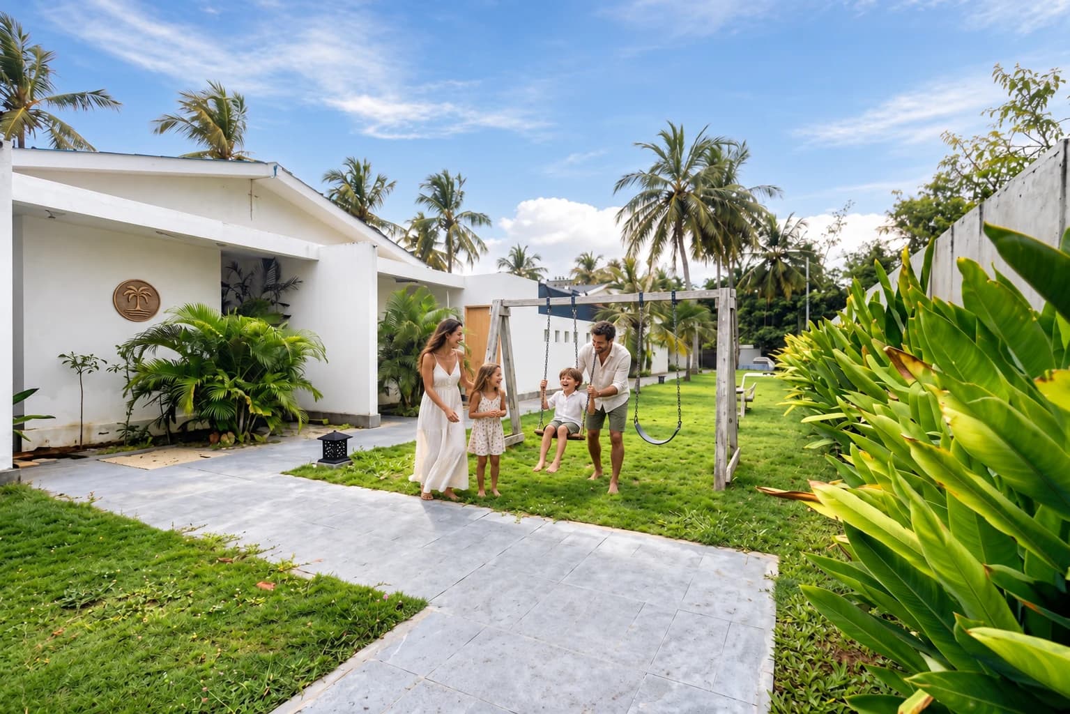 A family enjoying the garden swings beside the villas at Gili Khayangan